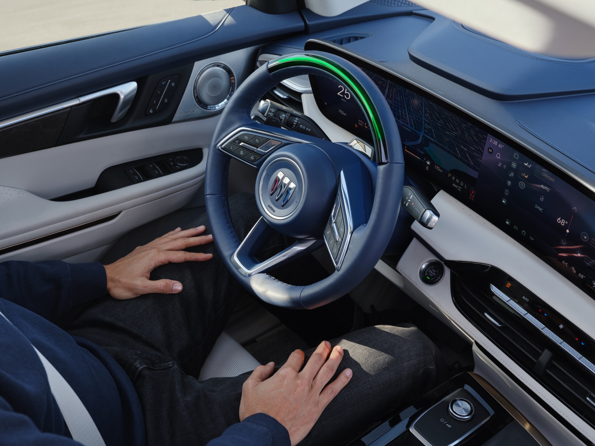 A Driver's Perspective of the Buick Interior, Featuring a Dark Blue Steering Wheel with a Green Accent and a Digital Dashboard Display