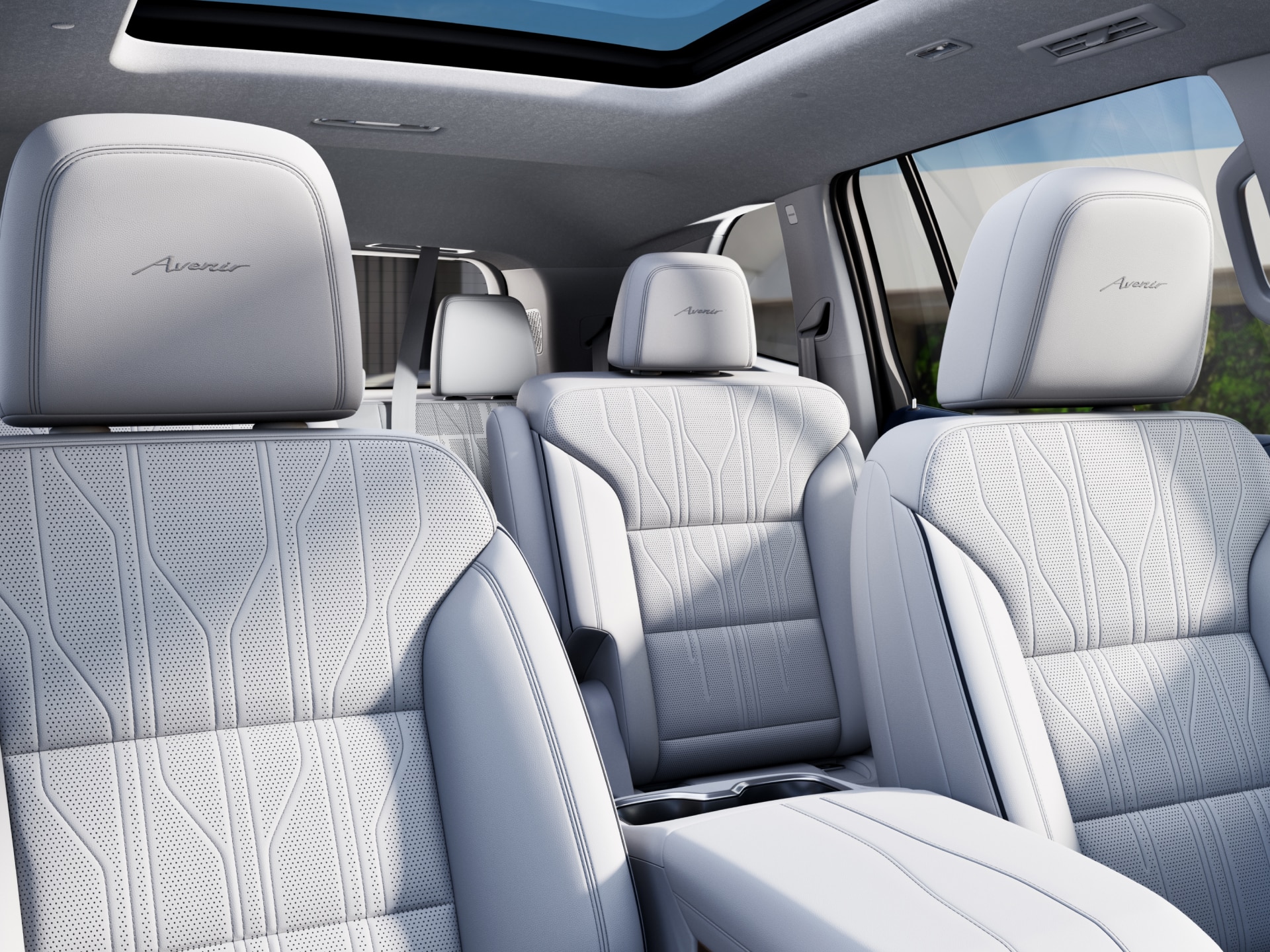 The Interior of a Buick Avenir Featuring Light Gray Perforated Leather Seats with Avenir Embroidered Headrests and a Panoramic Sunroof