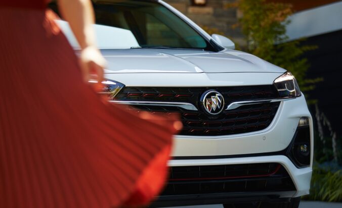 Women in Red Dress Walking Past a Summit White Buick