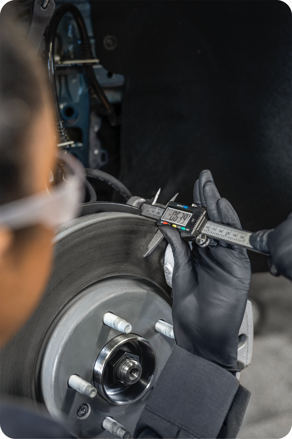 A Certified Technician Measuring the Brake Rotor on a Vehicle.