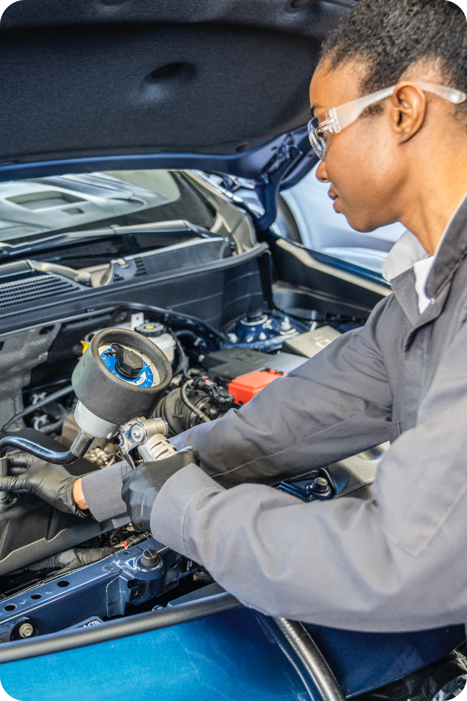 A Certified Technician Examining the engine of a Vehicle.