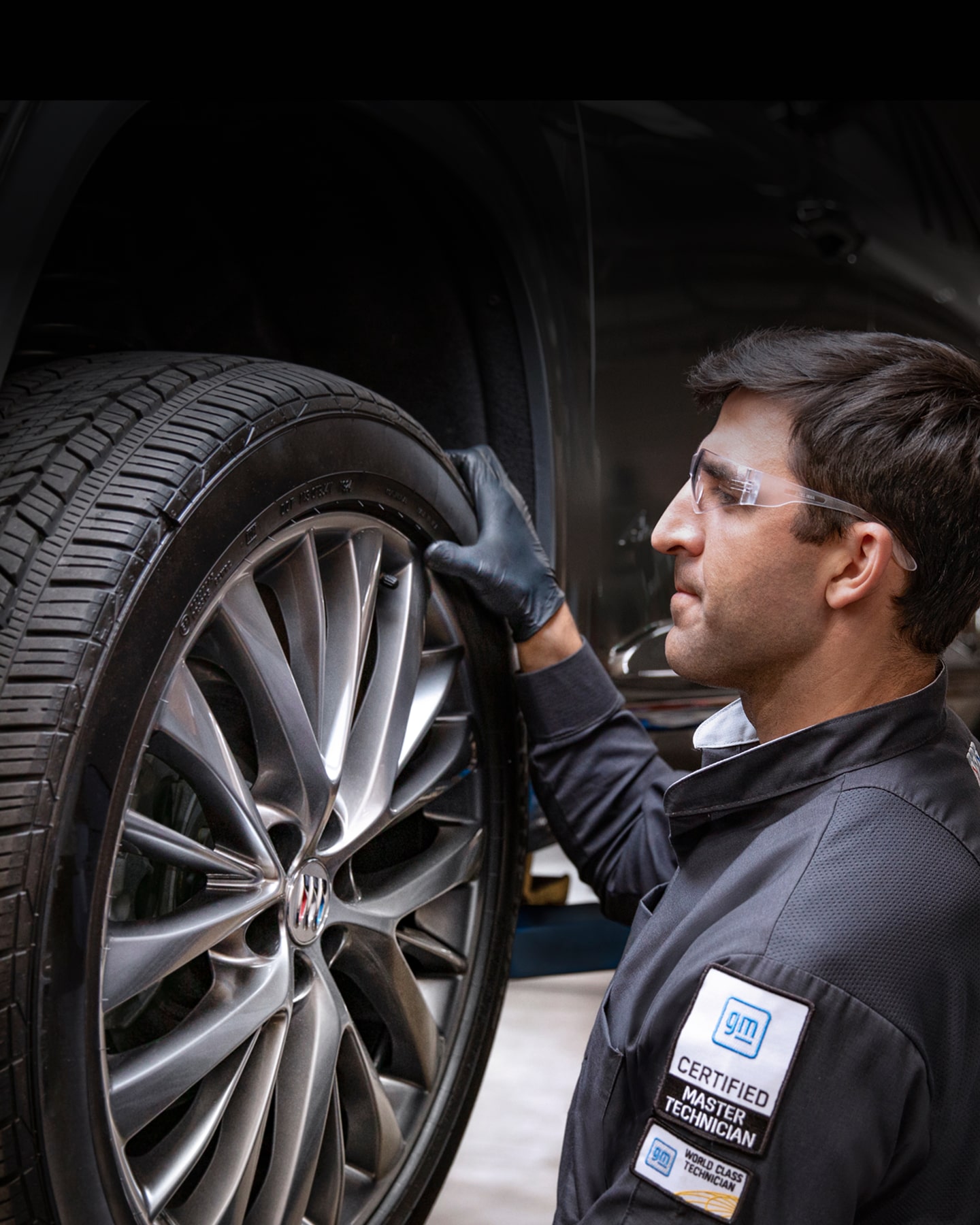 A Service Technician Inspecting the Tire of a Vehicle