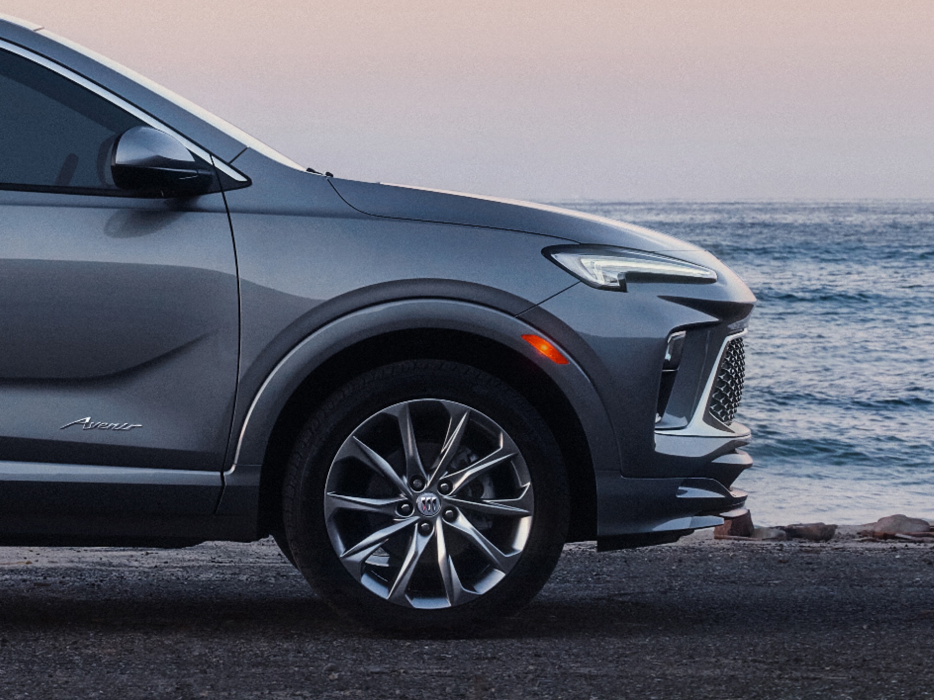 Profile View of the Front Section of the Buick Encore GX Small SUV Parked on a Beach
