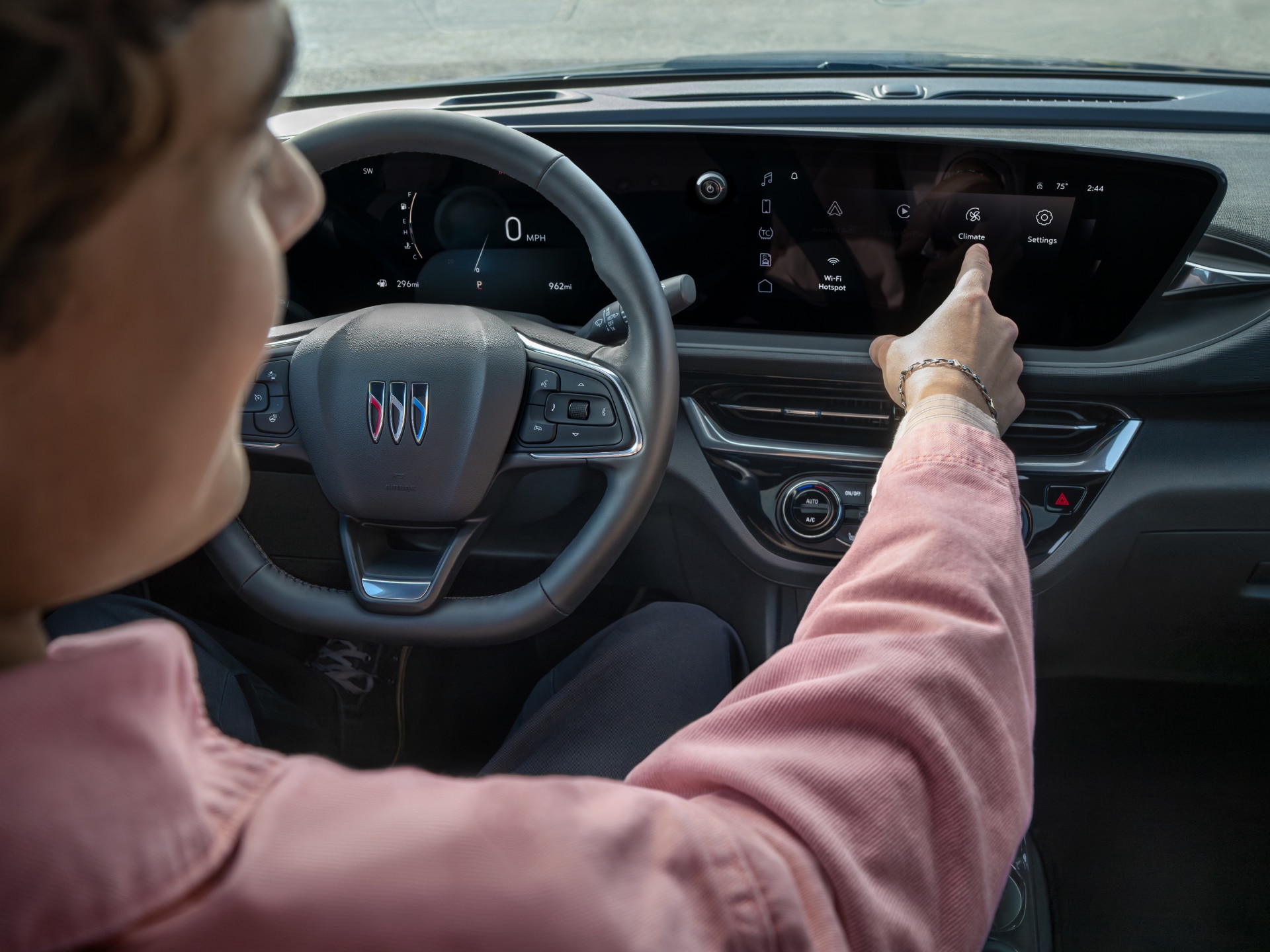 Over the Shoulder View of a Man Dressed in a Suit Driving his Buick Envista