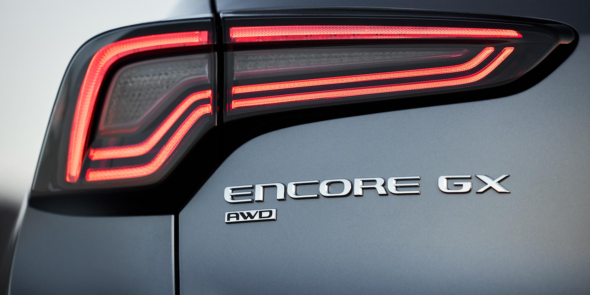 The Rear Taillight and Badging of a Gray Buick Encore GX Featuring AWD 