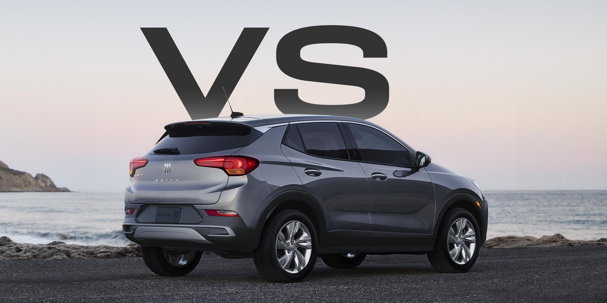 Front Three-quarters View of a White Buick Enclave Parked on a Beach as Waves Crash on the Shoreline