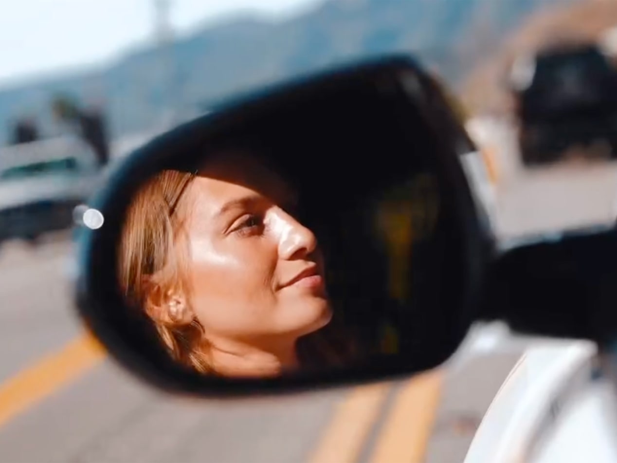 Anna Sitar’s Face Reflected in a Buick's Side Mirror with Sunlight Highlighting Her Features