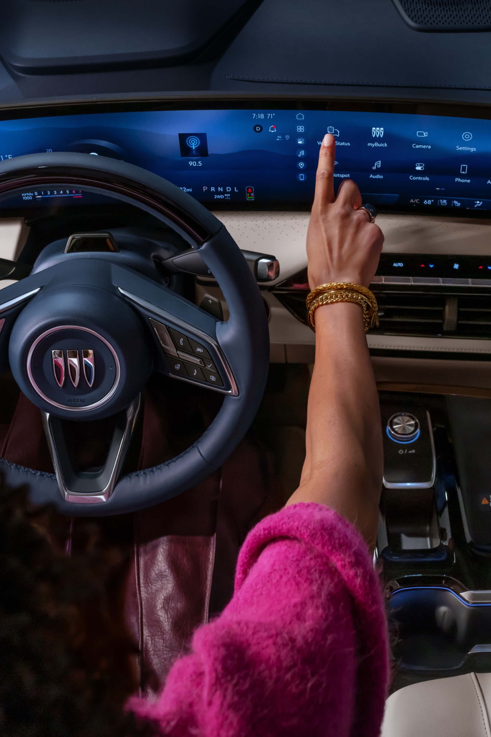 A Hand Interacting with the Large Touchscreen Infotainment System in a Modern Buick Vehicle's Interior