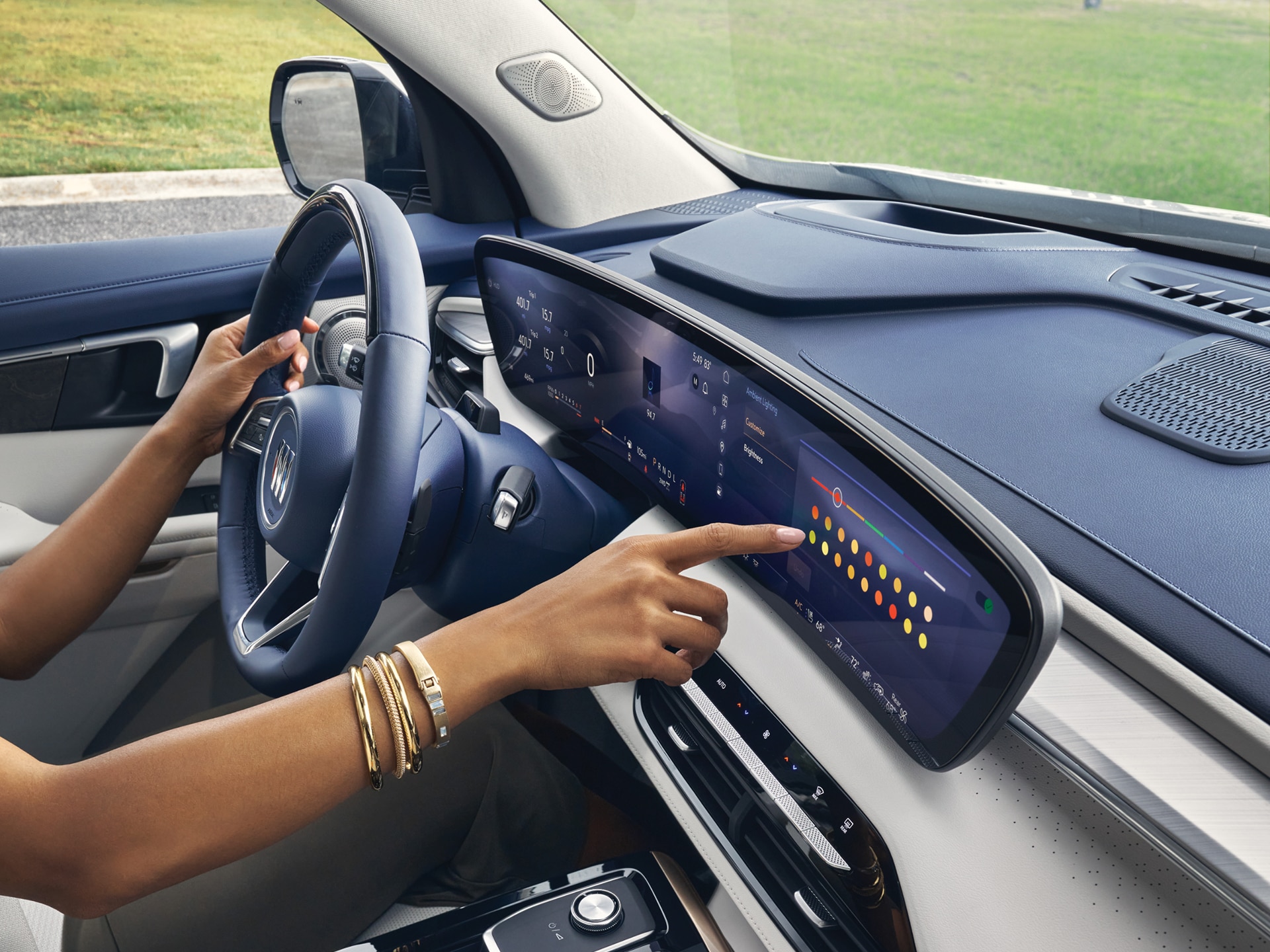 Close-up of a Woman Driving a Buick Enclave While Using the Touchscreen on the Infotainment System