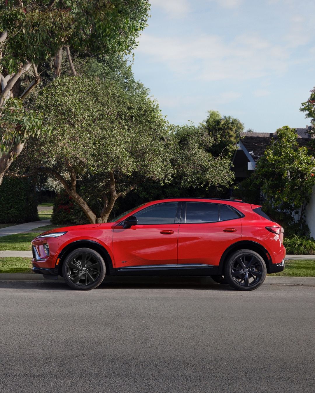 Profile View of a Red Buick SUV Parked on a Street Corner