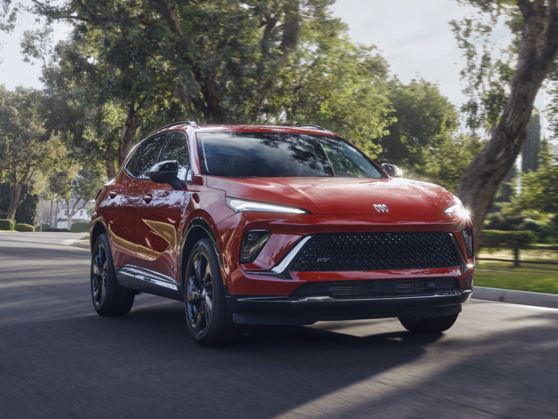 Front View of a Buick SUV Driving Through a Beautiful Green Park