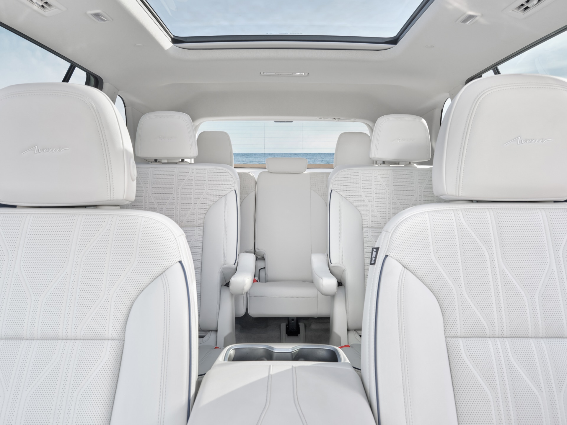 Interior View of the 3-Rows of White Leather Seats in a Buick SUV