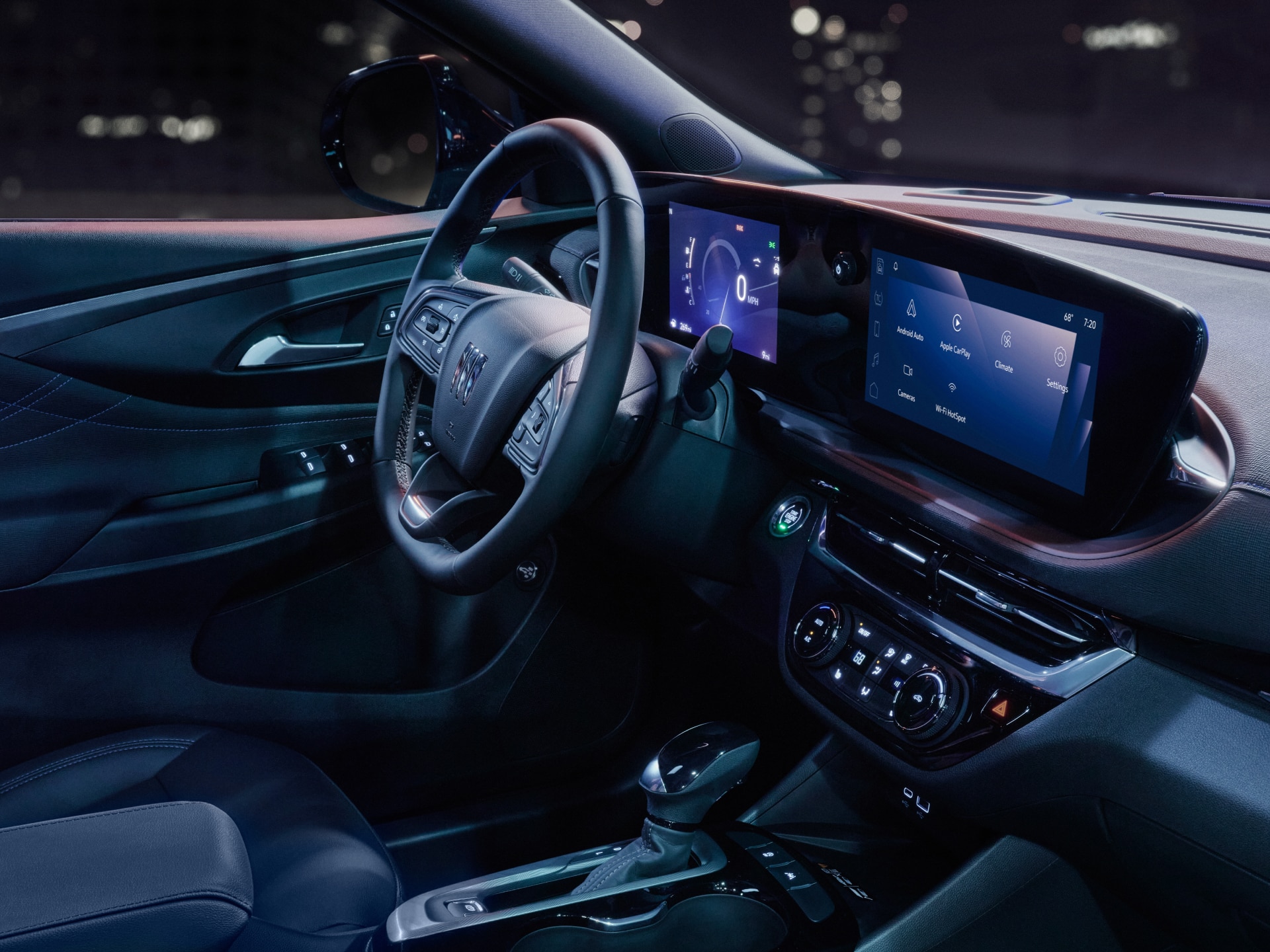 Interior View of the Dark Leather Steering Wheel and Center Console in a Buick SUV