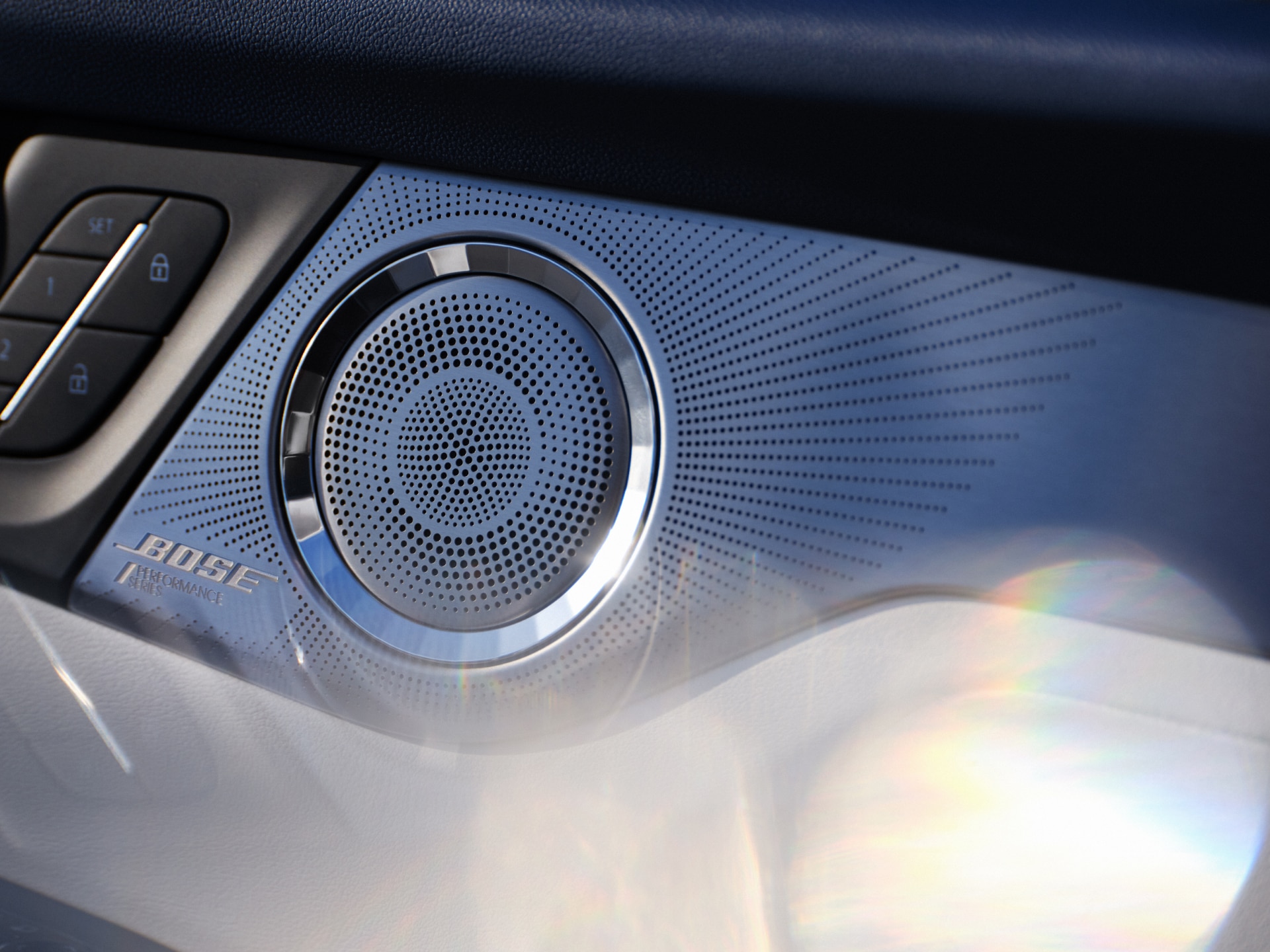 A Chrome Bose Performance Series Speaker with a Ray-Pattern Grille Located in a Buick Interior