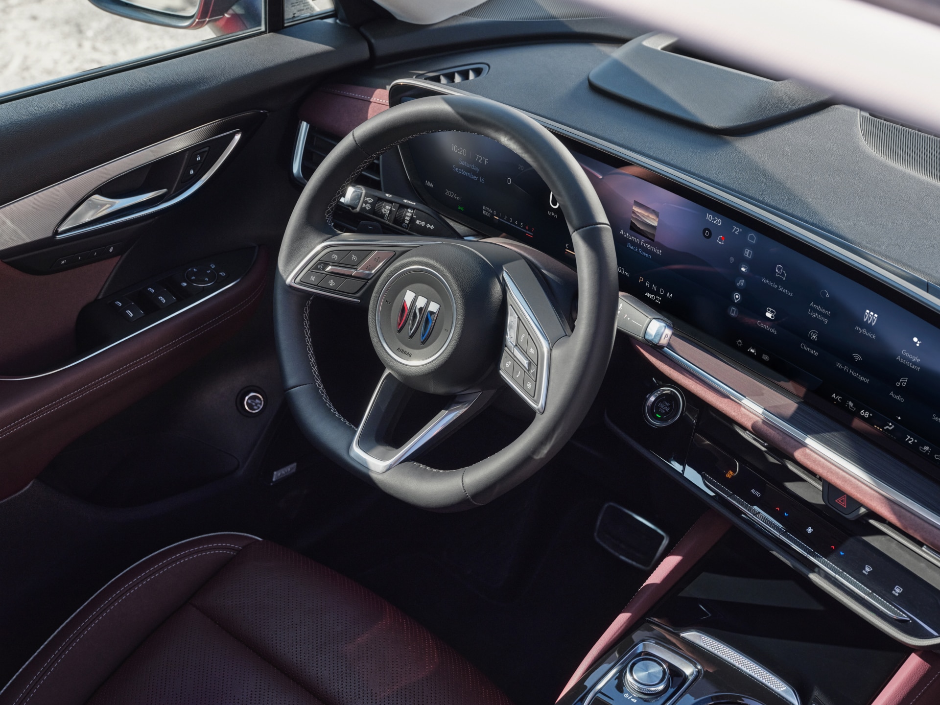 The Interior Dashboard of a Buick Vehicle Showing the Steering Wheel with the Buick Logo and a Widescreen Digital Display
