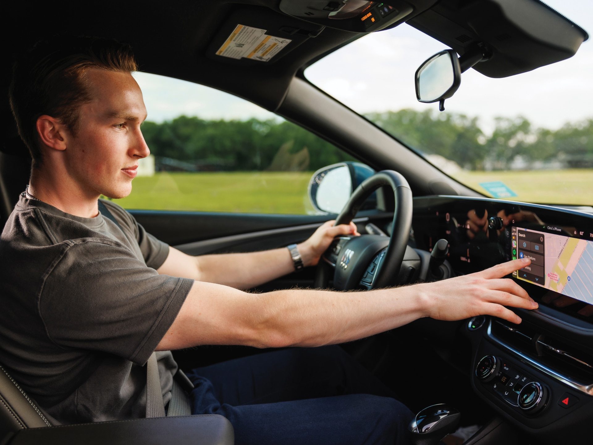 A Man Using the Infotainment System of a Buick Envista