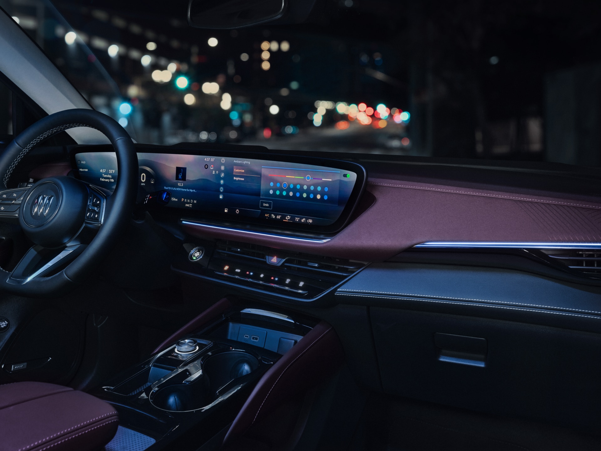 The Interior of a Buick Vehicle with Digital Screens Displaying Ambient Lighting Options and a Steering Wheel