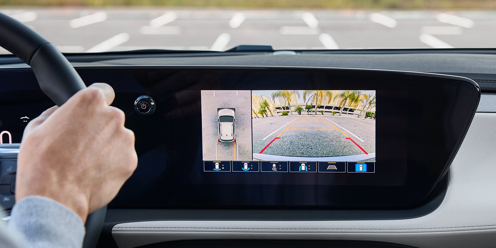 A Driver's Perspective from Inside a Buick Car Showing a Digital Dashboard Displaying Speed and Infotainment Details with a City Street Visible through the Windshield