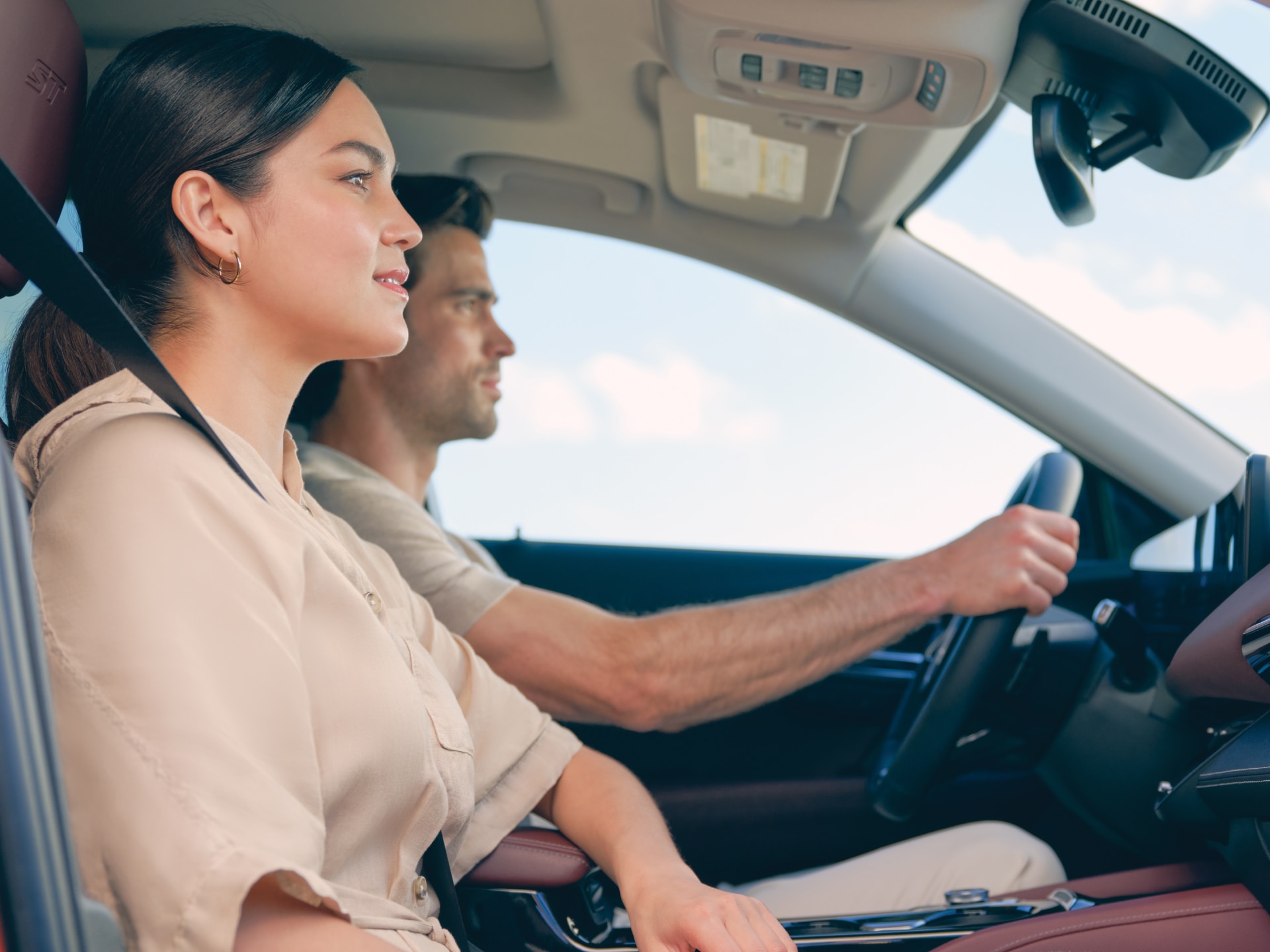 Profile View of a Man Driving and a Woman Sitting in the Passenger Seat