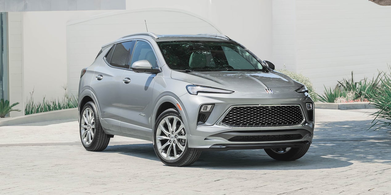 A Gray Buick SUV Parked in front of a Modern White Building with Green Landscaping