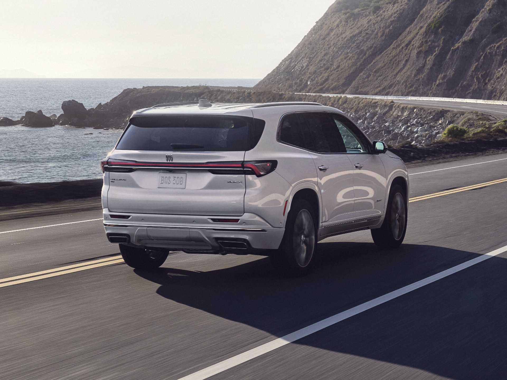 Rear View of the Buick Enclave Mid-Size SUV Driving Along the Coastline
