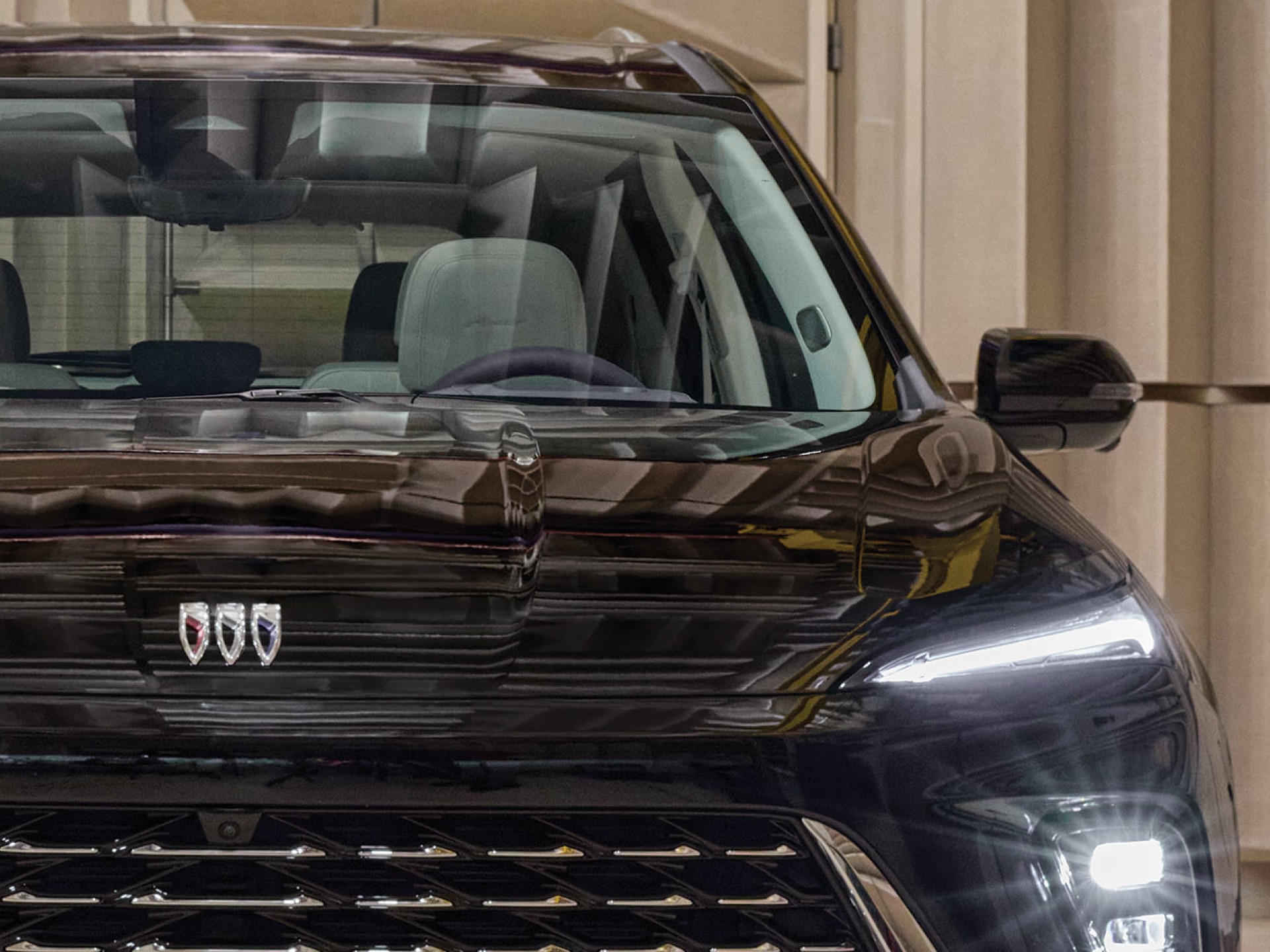 A GRAS Microphone Captures Sound Near the Grille of a Black Buick SUV in an Anechoic Chamber