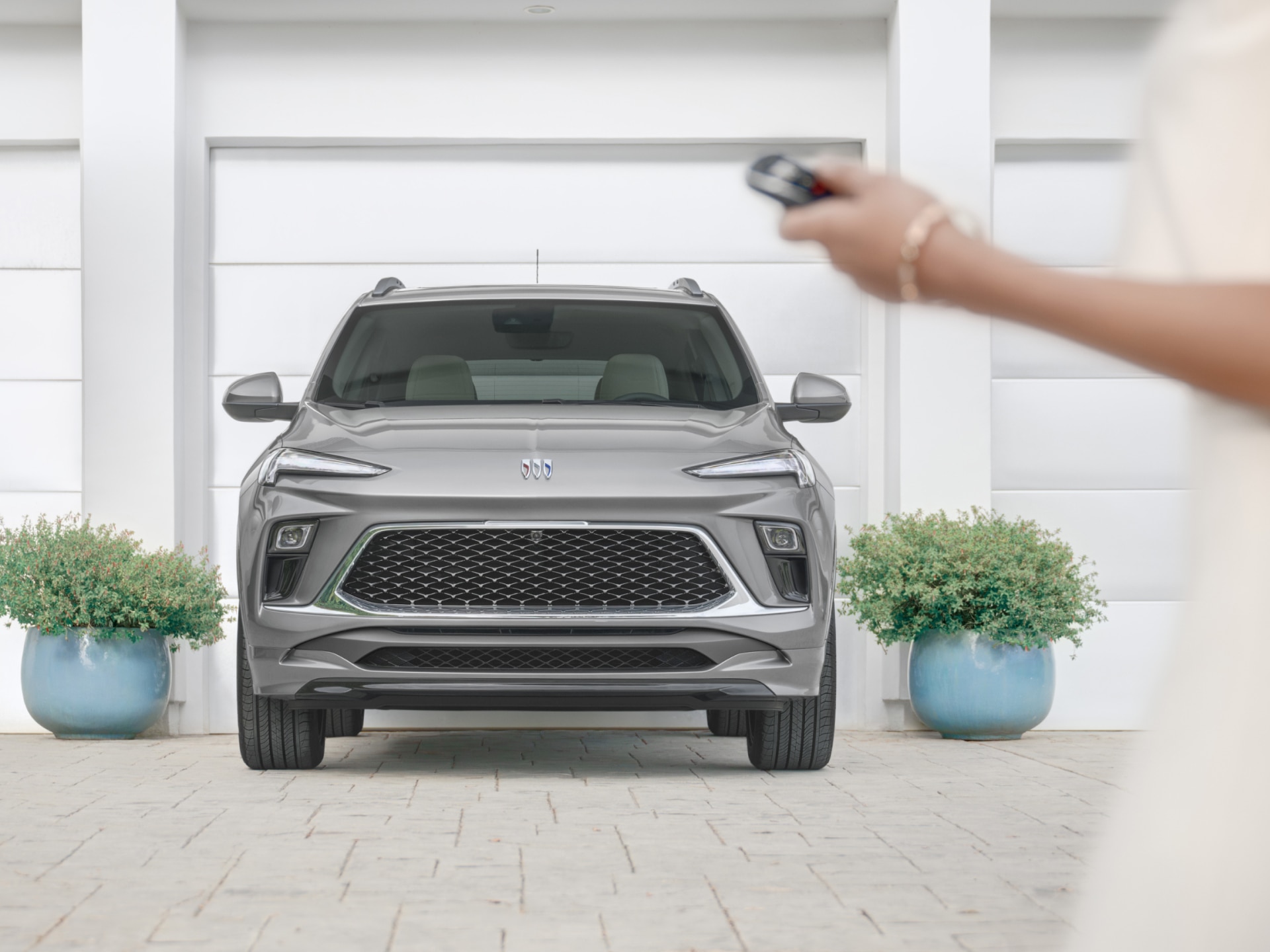 A Gray Buick SUV Parked in front of a White Building with Green Landscaping