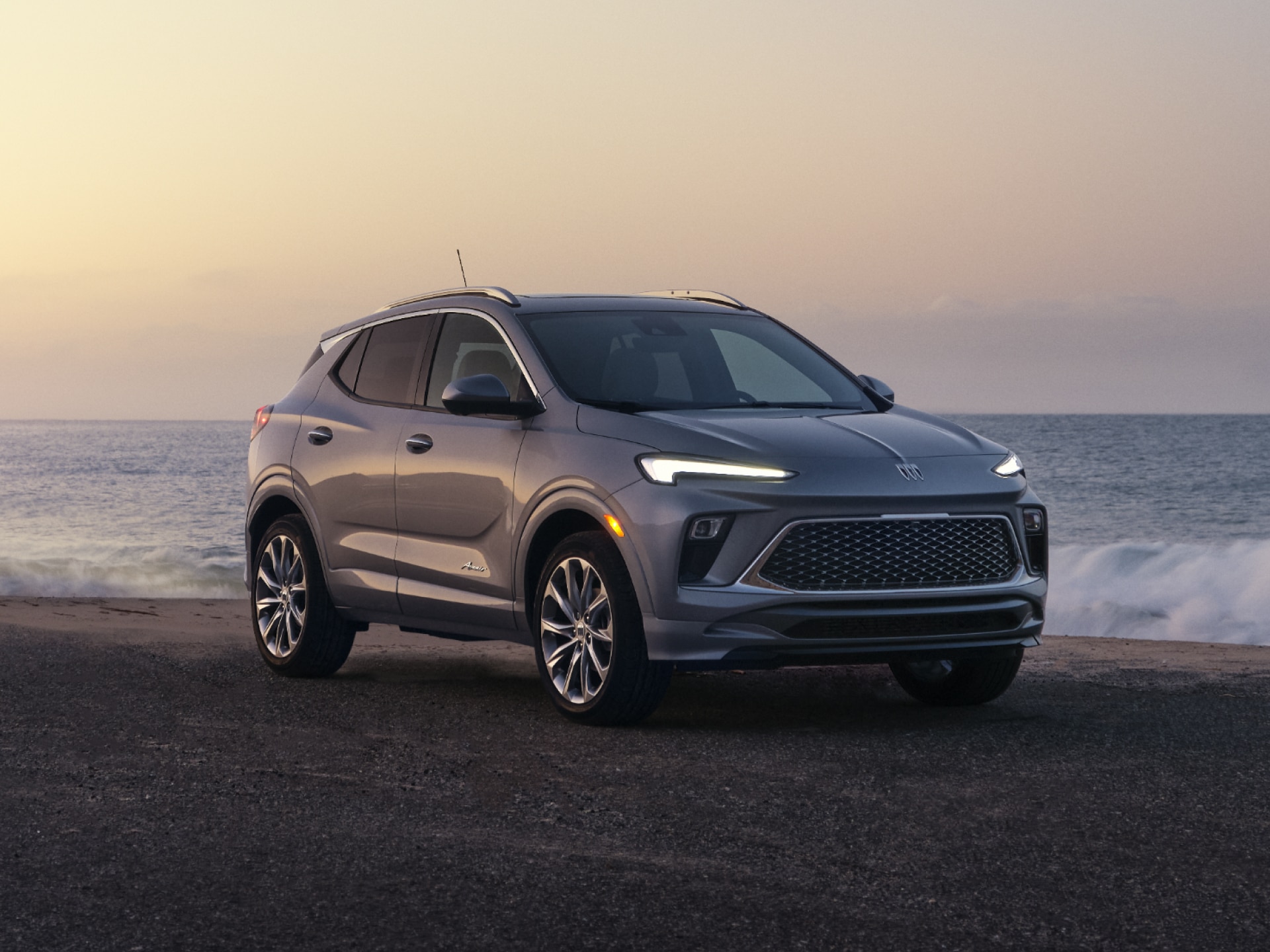 Front Three-Quarters View of the Buick Encore GX Parked on the Beach at Sunset