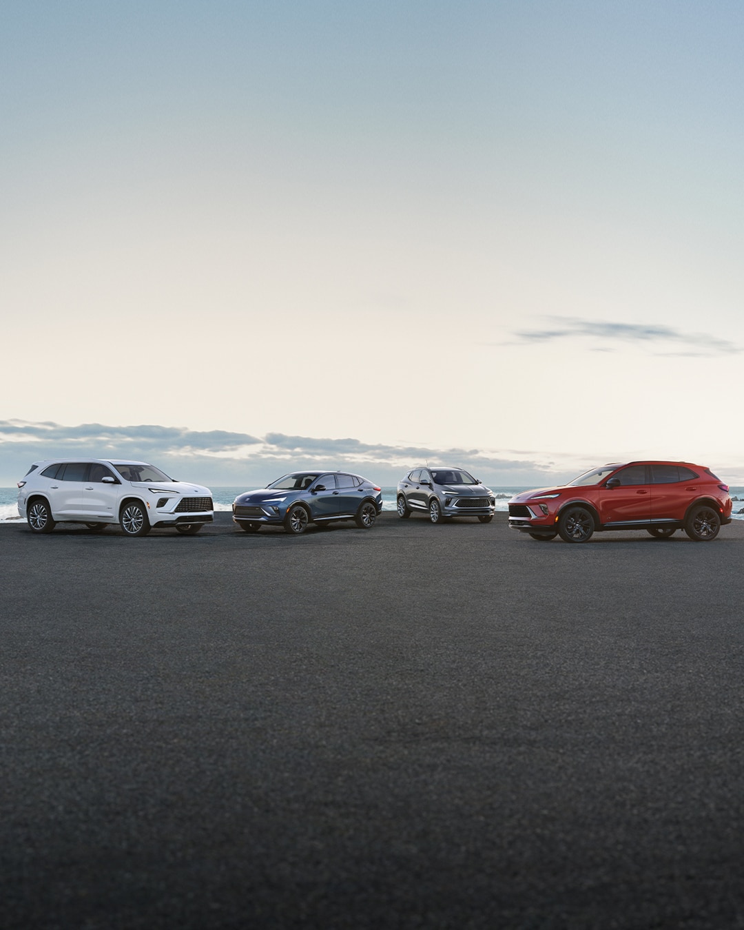 The 2025 Buick SUV Lineup Parked on a Beach at Sunset