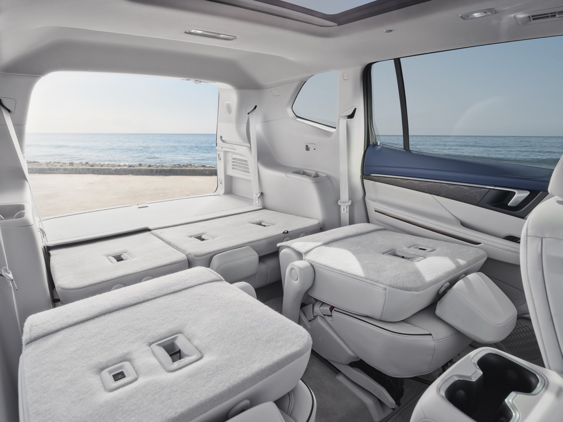 View of the open tailgate showing the Interior of a Buick SUV with the Rear Seats Folded Down