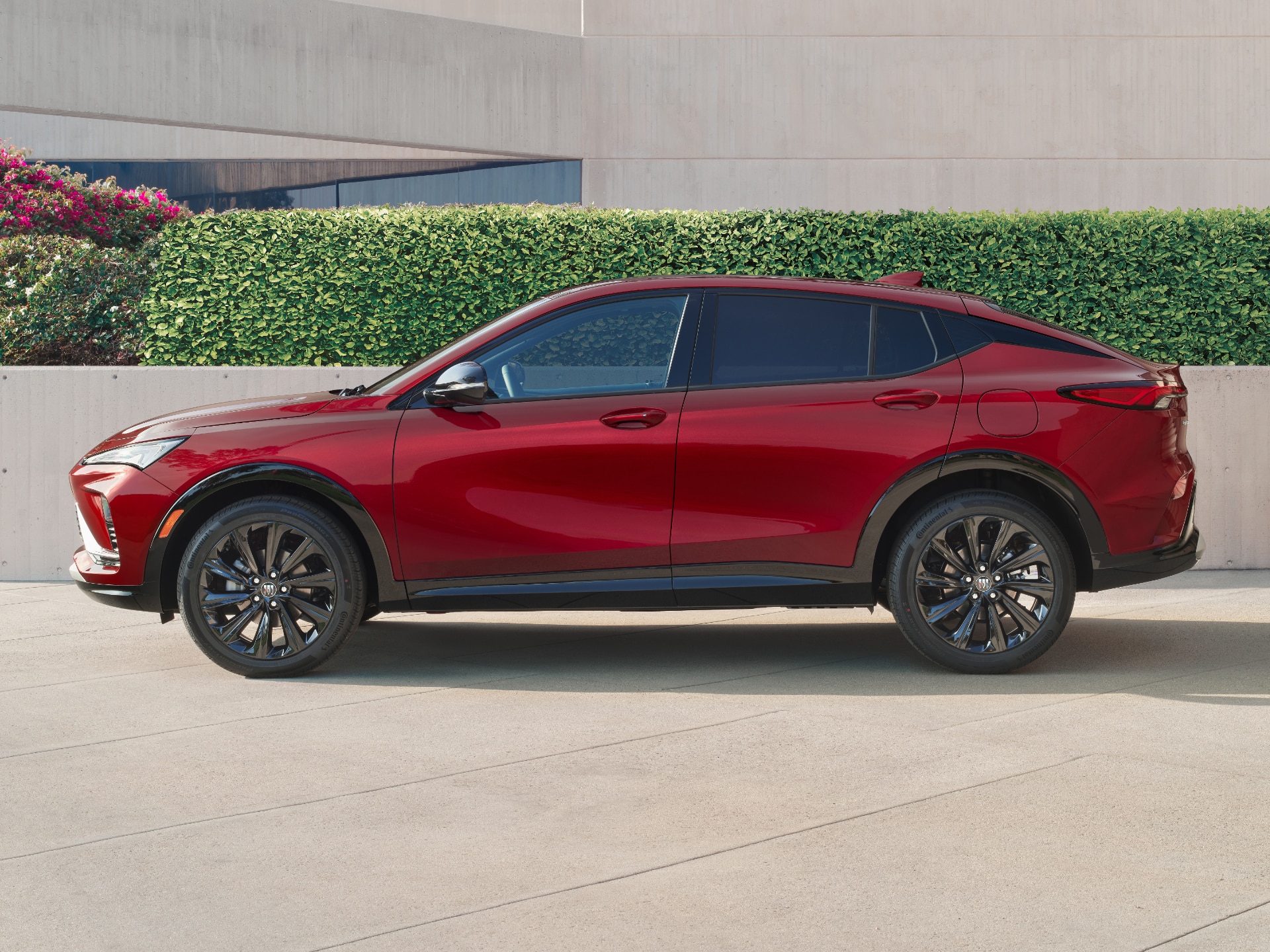 Exterior Side View of a Red Envista Sport Touring Parked in Front of a Building