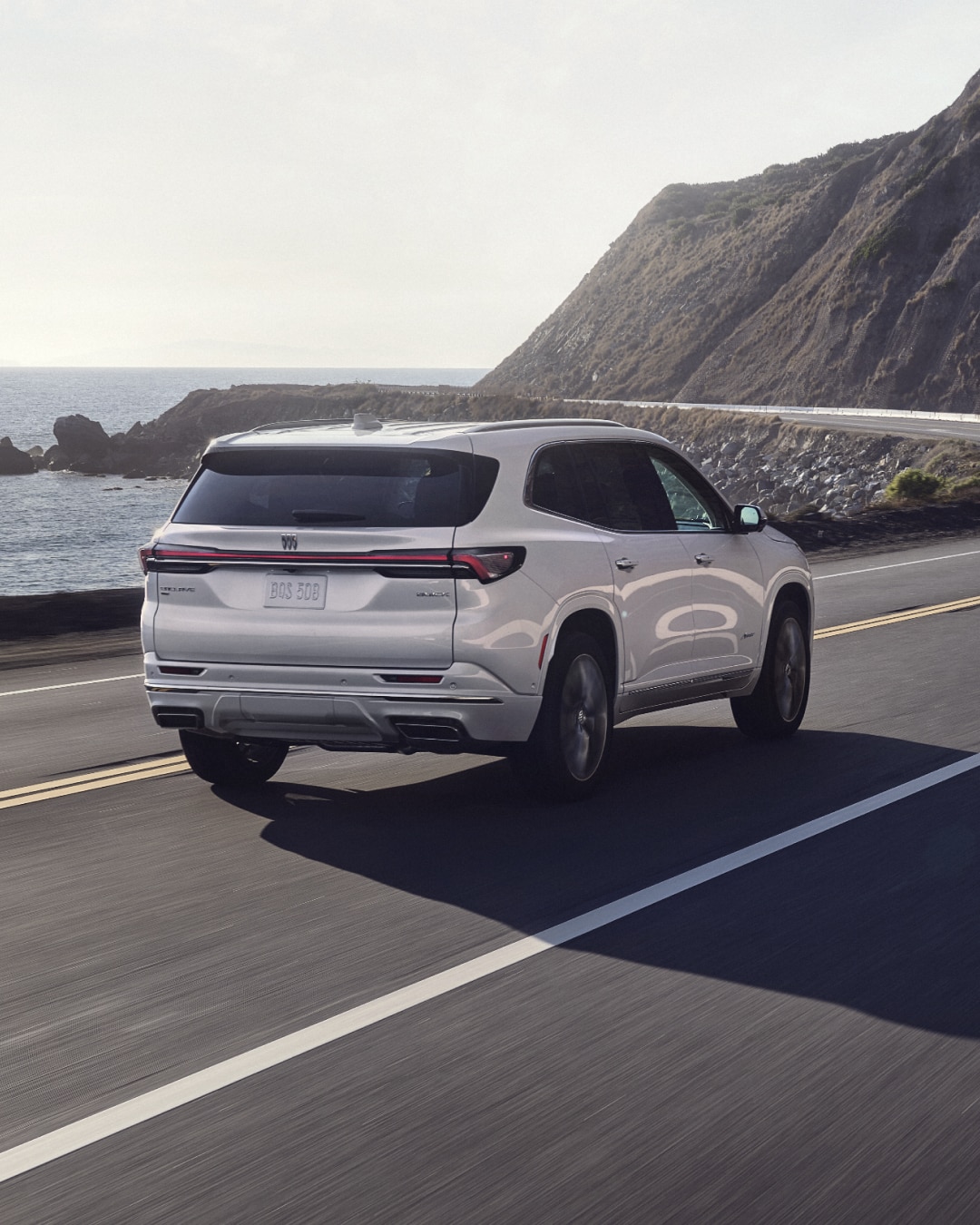 Rear View of the Buick Enclave Mid-Size SUV Driving Along the Coastline
