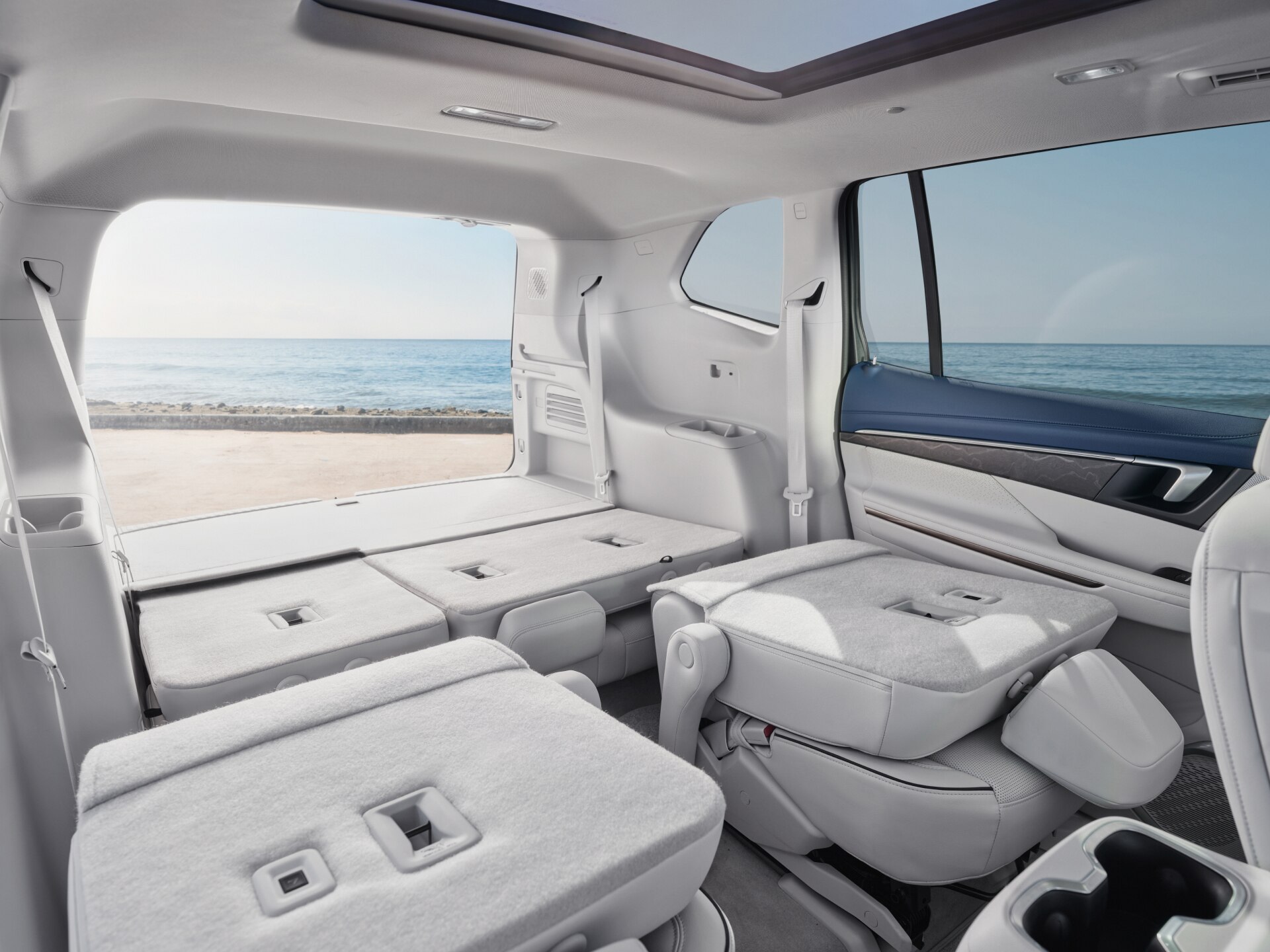 A Spacious Buick SUV Interior, with the Third-Row Seats Folded Flat for Maximum Cargo Capacity, Overlooks the Ocean