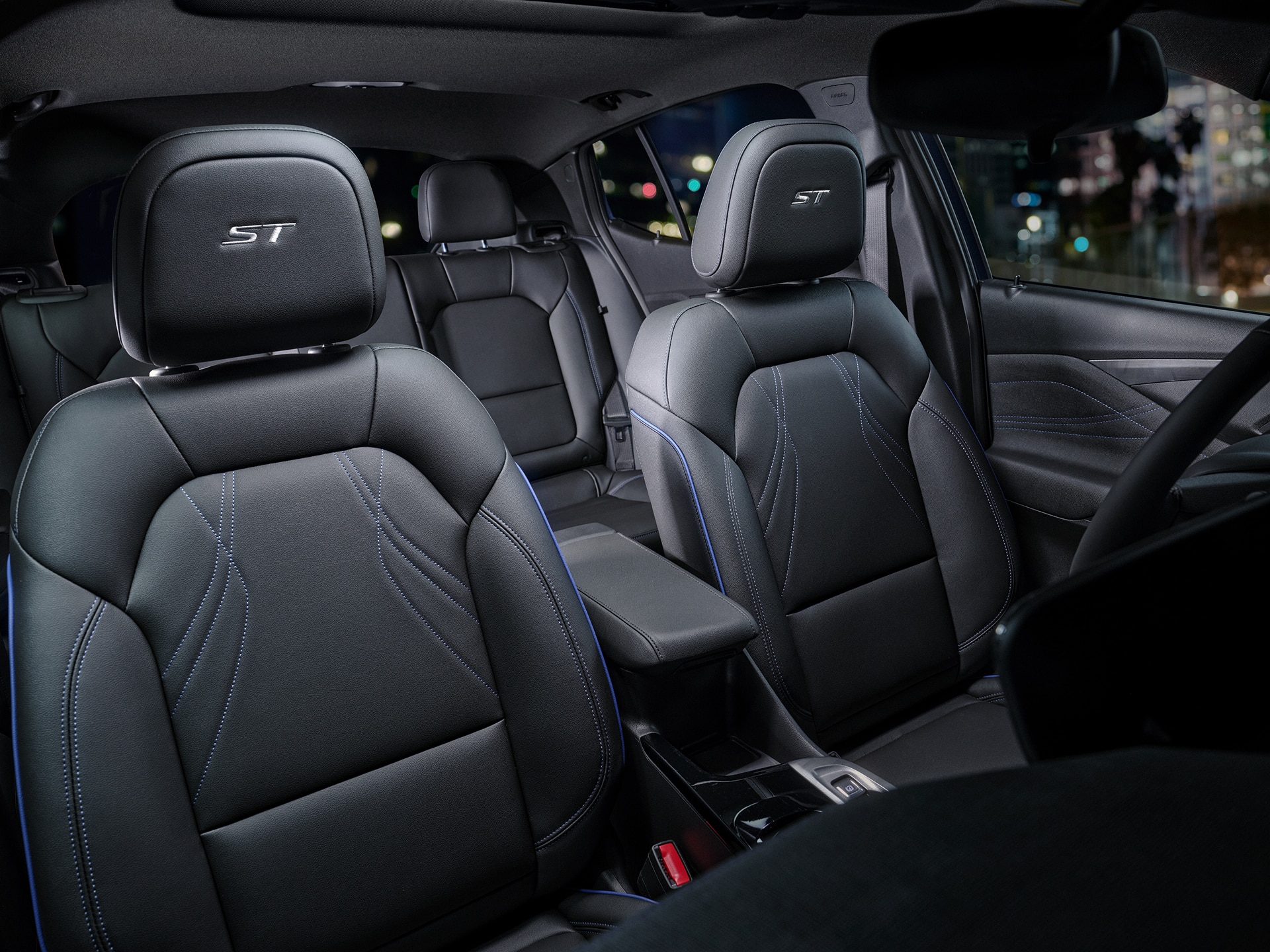 The Interior of a Buick SUV Featuring Black Leather Seats with Blue Stitching and an ST Logo