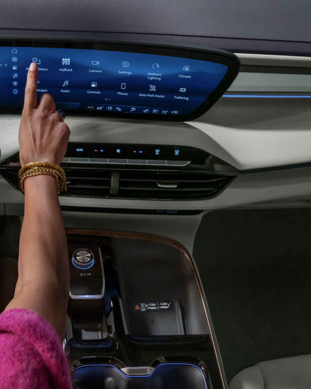 Women using the infotainment screen on a 2027 Buick Enclave