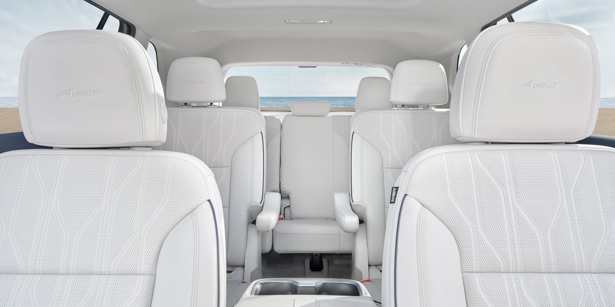 Interior of a Buick Enclave, Showing Rows of White Leather Seats and a Panoramic Sunroof
