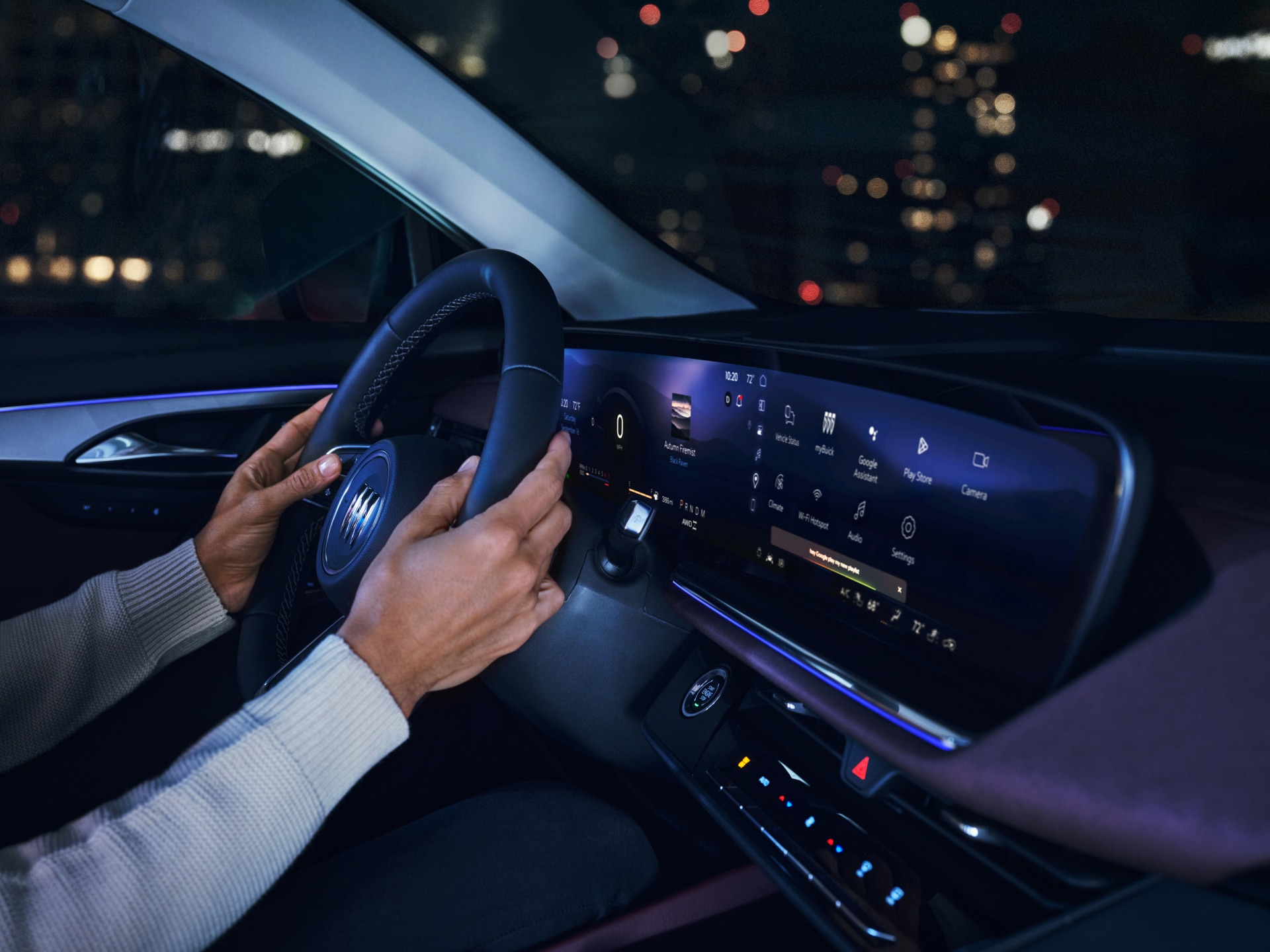 Hands on the Steering Wheel of a Buick Vehicle at Night, Showing the Digital Dashboard Display with Various Icons