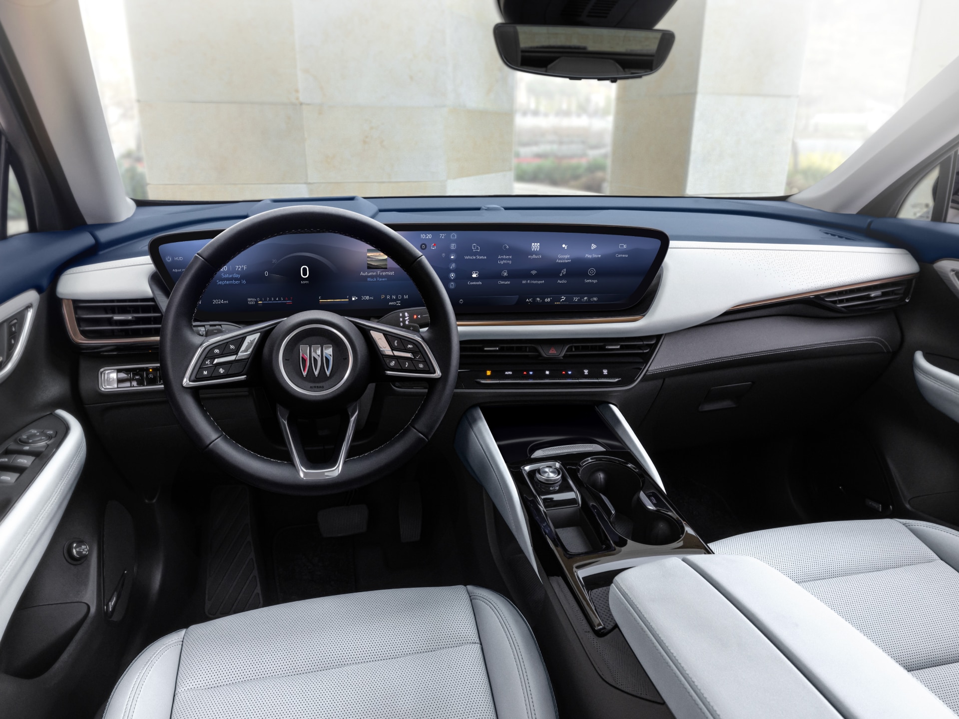 View of a White-and-Blue Buick Interior Including the Steering Wheel, Center Console and Dashboard