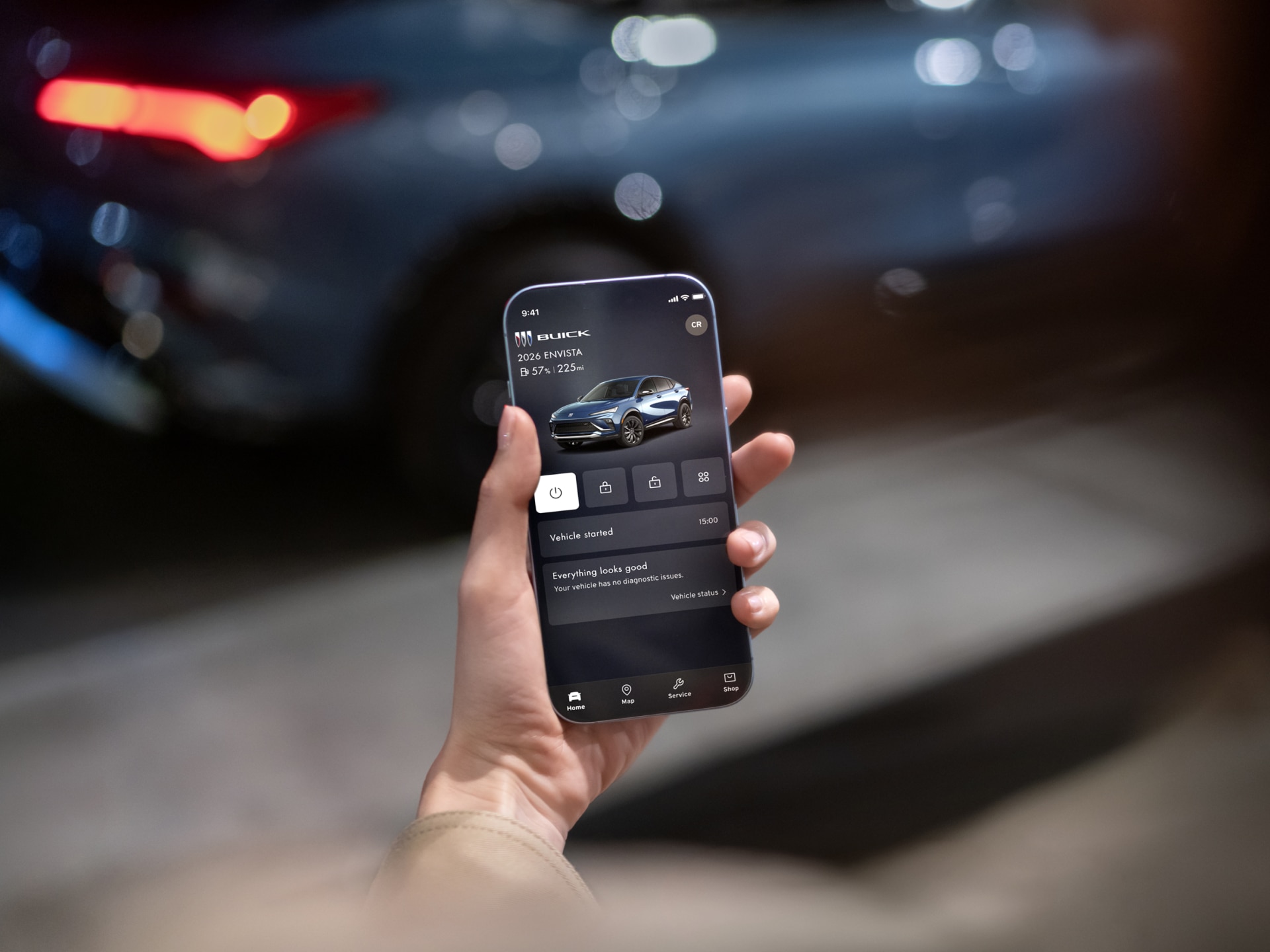 Person Holding Smartphone with the myBuick Mobile App Open on Screen
