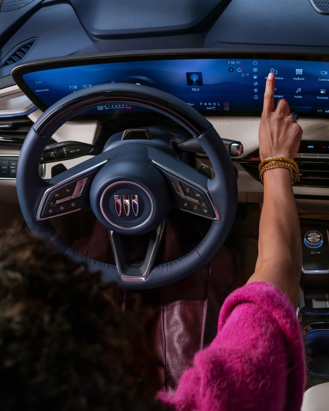 A Hand Interacting with the Large Touchscreen Infotainment System in a Modern Buick Vehicle's Interior
