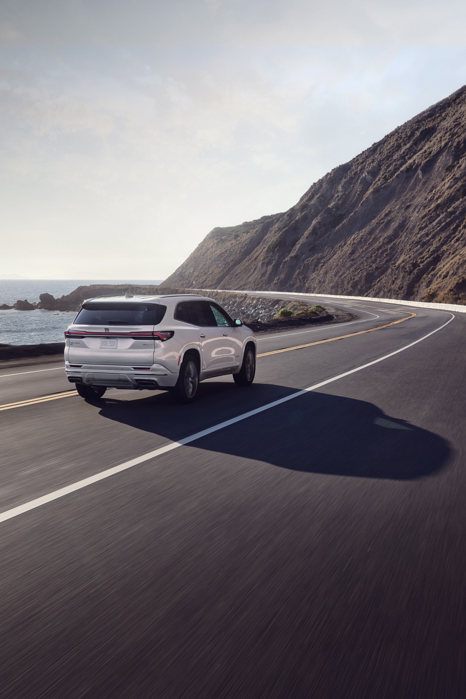A Silver Buick SUV driving on a Coastal Road