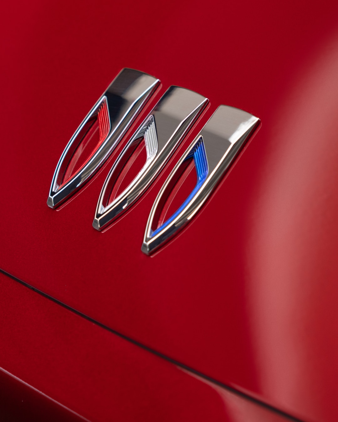 Close-up View of a Buick Logo on the Hood of a Red Buick Vehicle