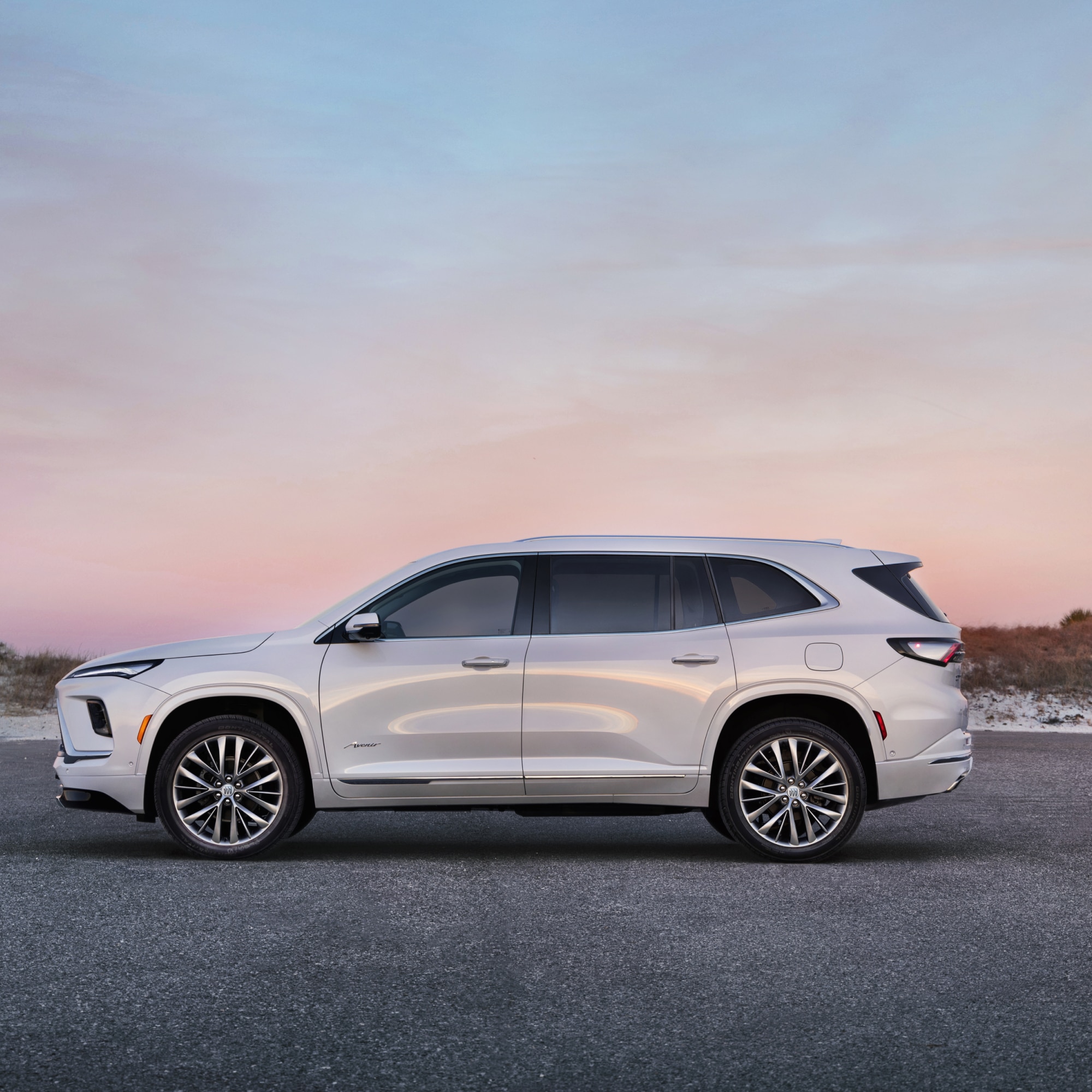 Profile View of a White Buick SUV with a Beautiful Sunset in the Background