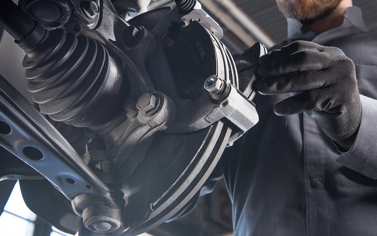 A Vehicle Mechanic Is Working on a Wheel