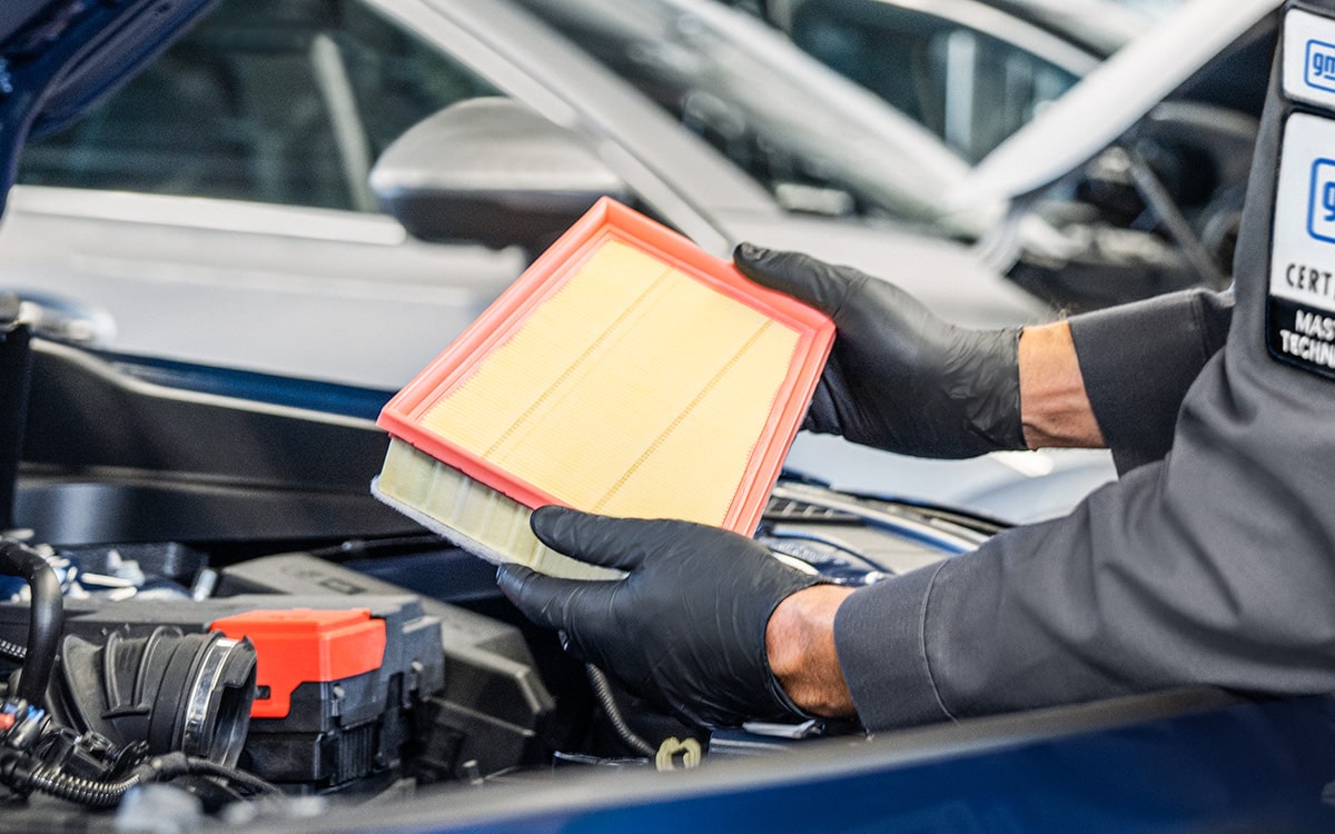 A Mechanic Is Replacing the Air Filter of a Vehicle