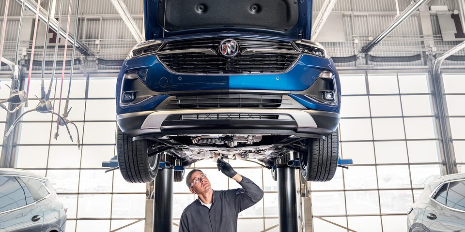 Buick Certified Service Technician Inspecting Underside of a Vehicle