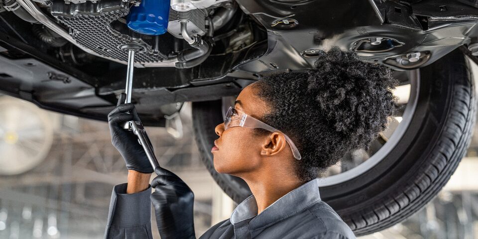 Buick Certified Service Technician Using a Tool to Work on a Vehicle