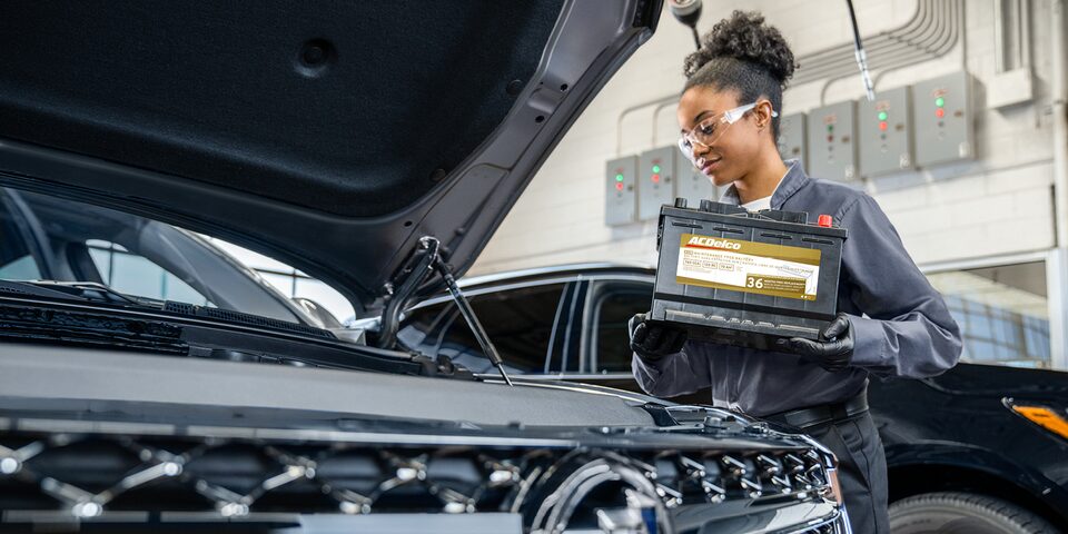 A Buick Certified Service Technician Installing an ACDelco Gold Battery in a GM Vehicle
