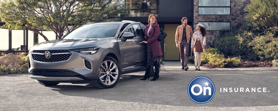 Buick Avenir parked in the driveway of a modern home. Woman is at the driver’s side door while a man and a young woman walk out of the home. OnStar Insurance logo is in the bottom right corner.