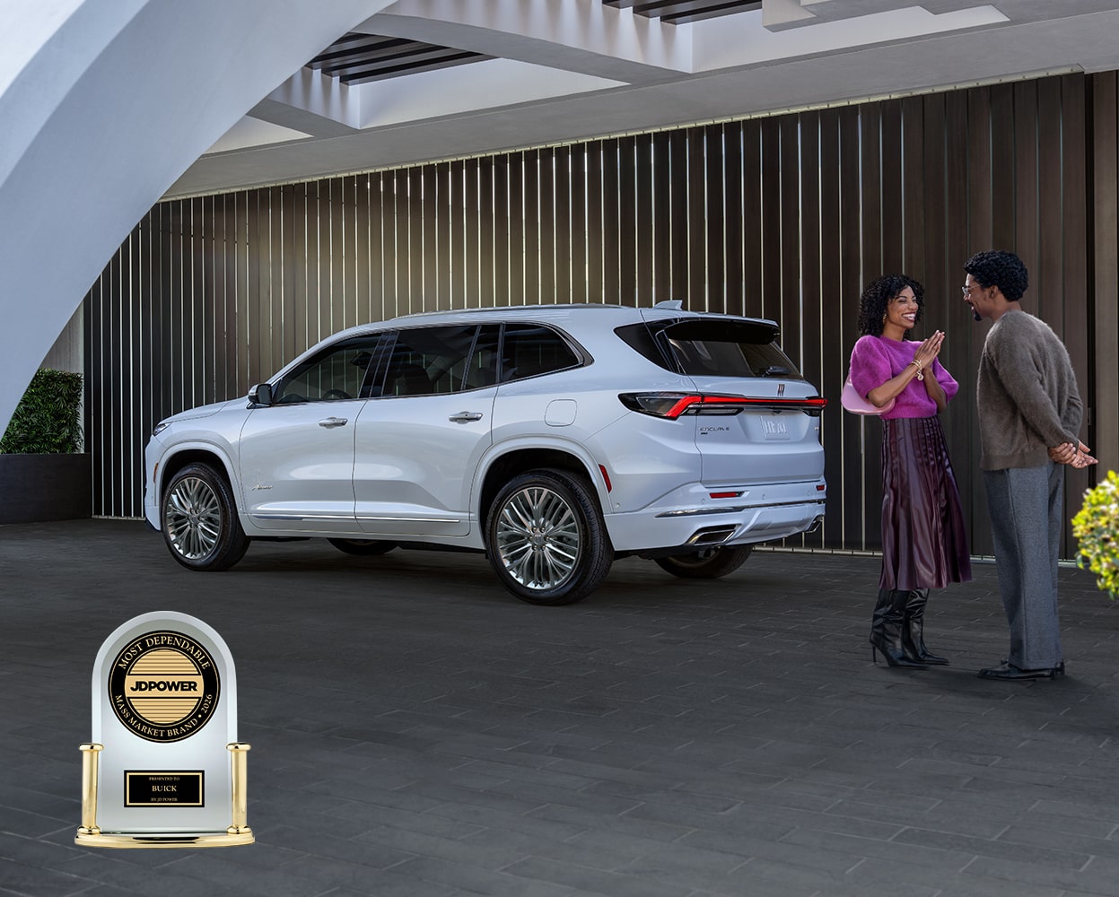 A White Buick SUV Parked in a Modern Architecturally Designed Driveway with Curved Concrete and Potted Plants